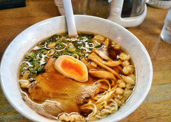 Ramen, pork, bamboo, spring onions and half a soft-boiled egg in a rich broth.